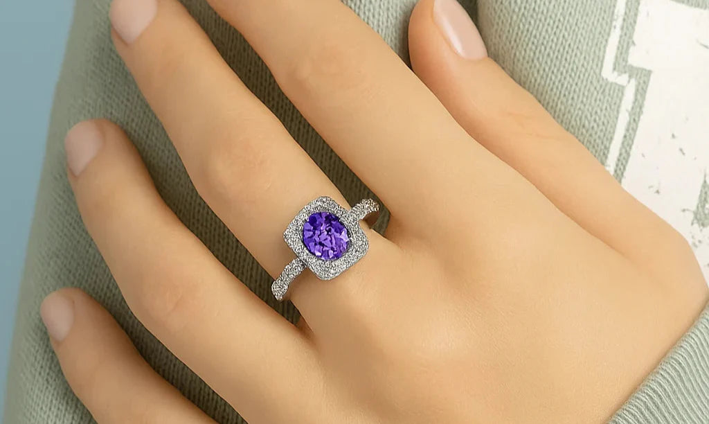 Model wearing Cavell Feel Timeless sterling silver ring featuring a natural tanzanite gemstone surrounded by cubic zirconia accents with hidden rose quartz gemstone inside the band