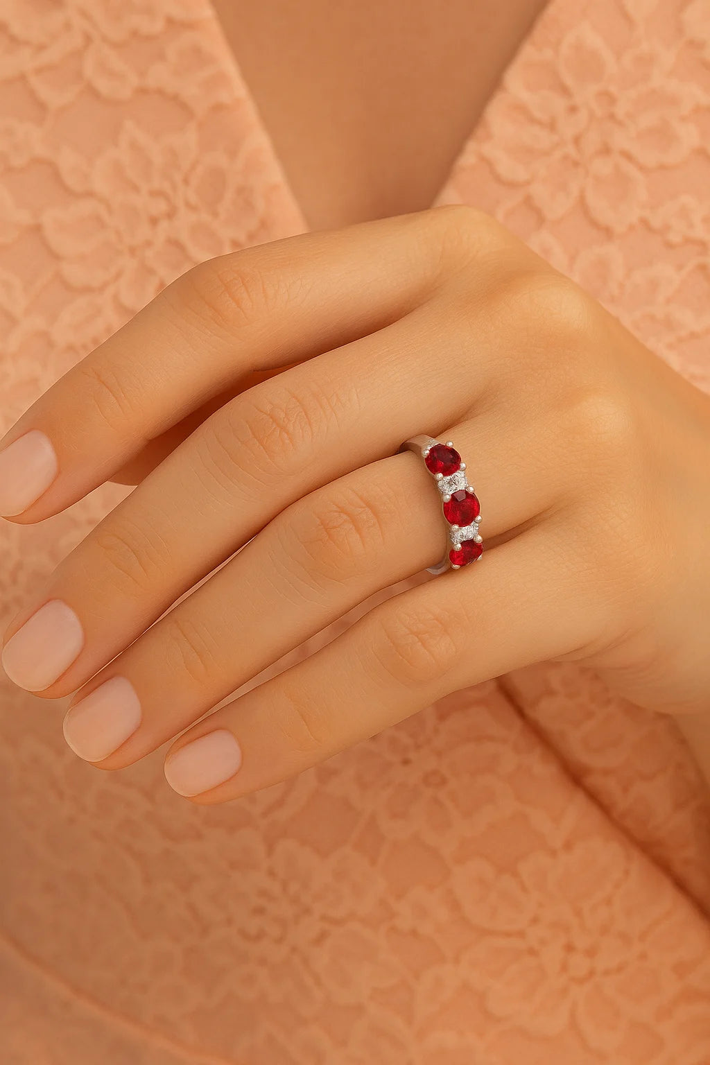 Model wearing Cavell Trilogy of Loyalty natural ruby ring in sterling silver surrounded by round-cut cubic zirconia accents