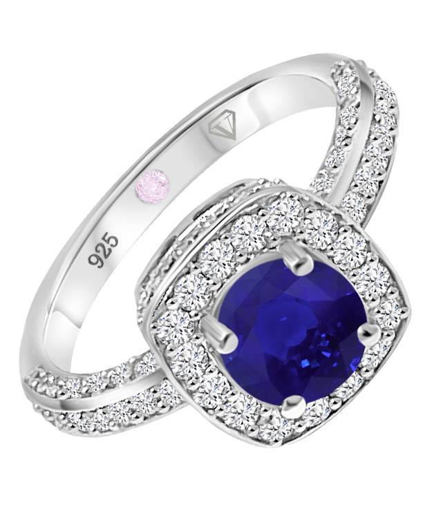 Angled view of Cavell Everlasting Devotion sterling silver ring featuring a natural sapphire gemstone surrounded by round-cut cubic zirconia accents and hidden rose quartz gemstone inside the band