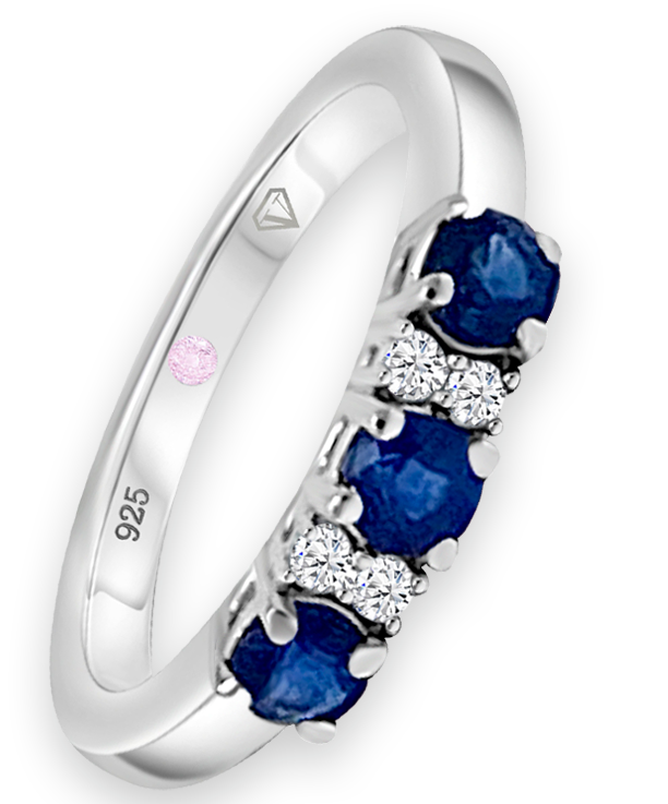 Angled view of Cavell Trilogy of Loyalty sterling silver ring featuring a natural sapphire gemstone surrounded by round-cut cubic zirconia accents and hidden rose quartz gemstone inside the band