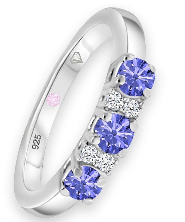 Angled view of Cavell Trilogy of Loyalty sterling silver ring featuring a natural tanzanite gemstone surrounded by round-cut cubic zirconia accents and hidden rose quartz gemstone inside the band