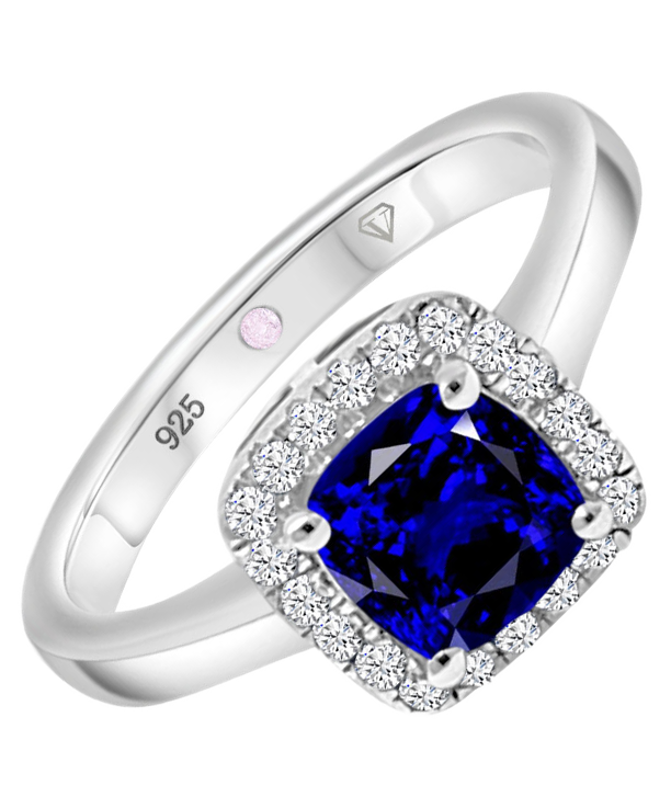 Angled view of Cavell Touch of Luxury sterling silver ring featuring a natural sapphire gemstone surrounded by round-cut cubic zirconia accents and hidden rose quartz gemstone inside the band