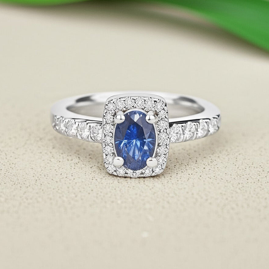 Cavell Feel Timeless natural tanzanite ring in sterling silver surrounded by round-cut cubic zirconia accents placed on a surface