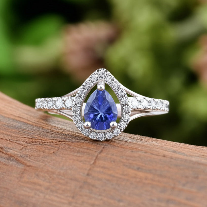 Cavell Tear Drop of Joy natural tanzanite ring in sterling silver surrounded by round-cut cubic zirconia accents placed on a surface