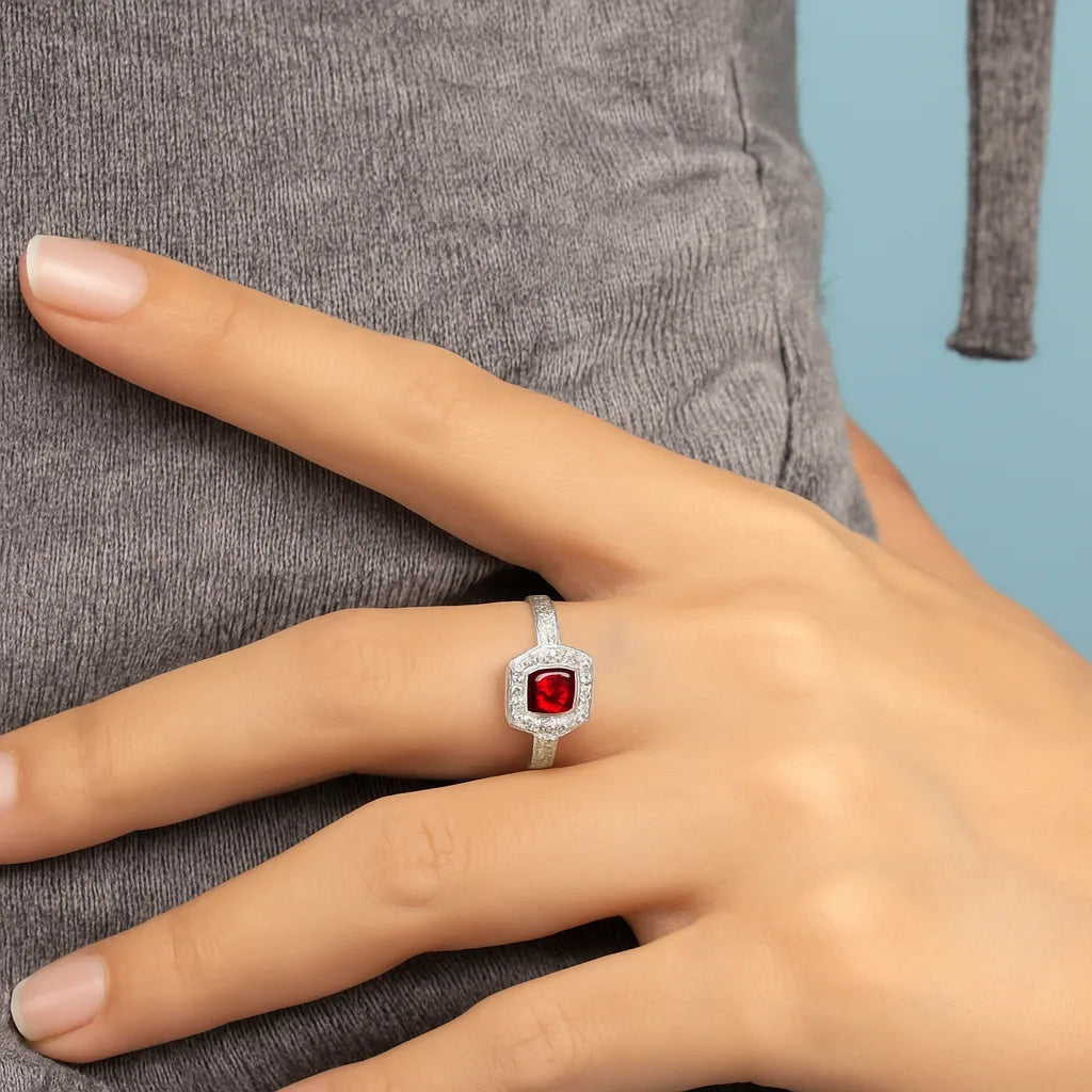 Model wearing Cavell Everlasting Devotion natural ruby ring in sterling silver surrounded by round-cut cubic zirconia accents
