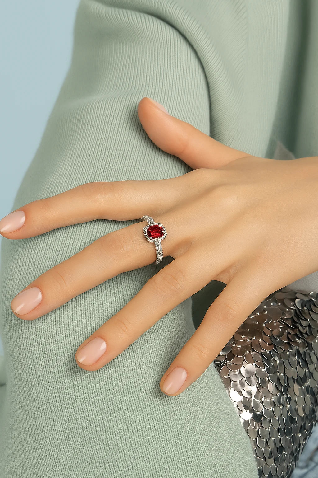 Model wearing Cavell Feel Timeless natural ruby ring in sterling silver surrounded by round-cut cubic zirconia accents