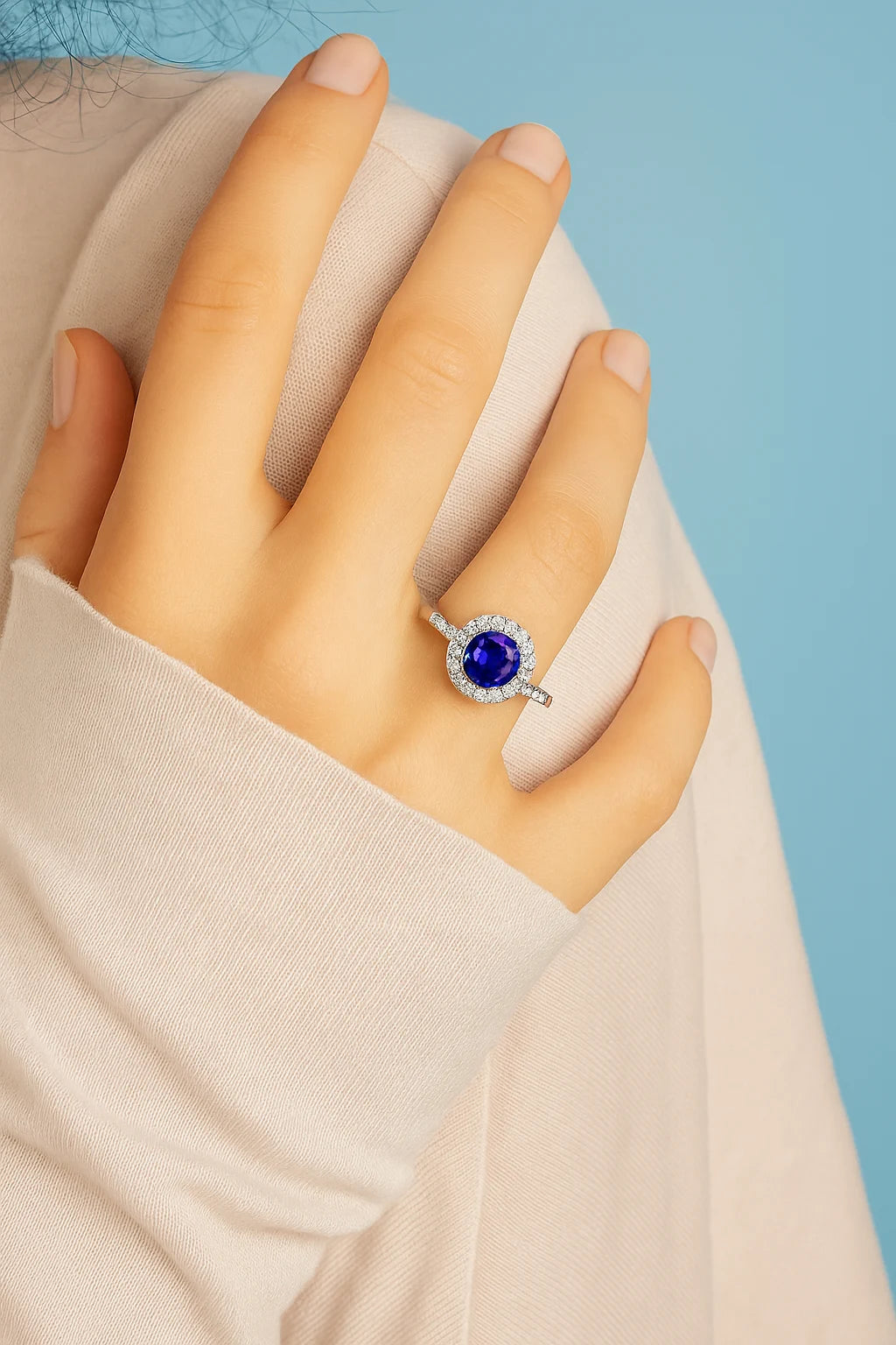 Model wearing Cavell Eternal Love natural sapphire ring in sterling silver surrounded by round-cut cubic zirconia accents