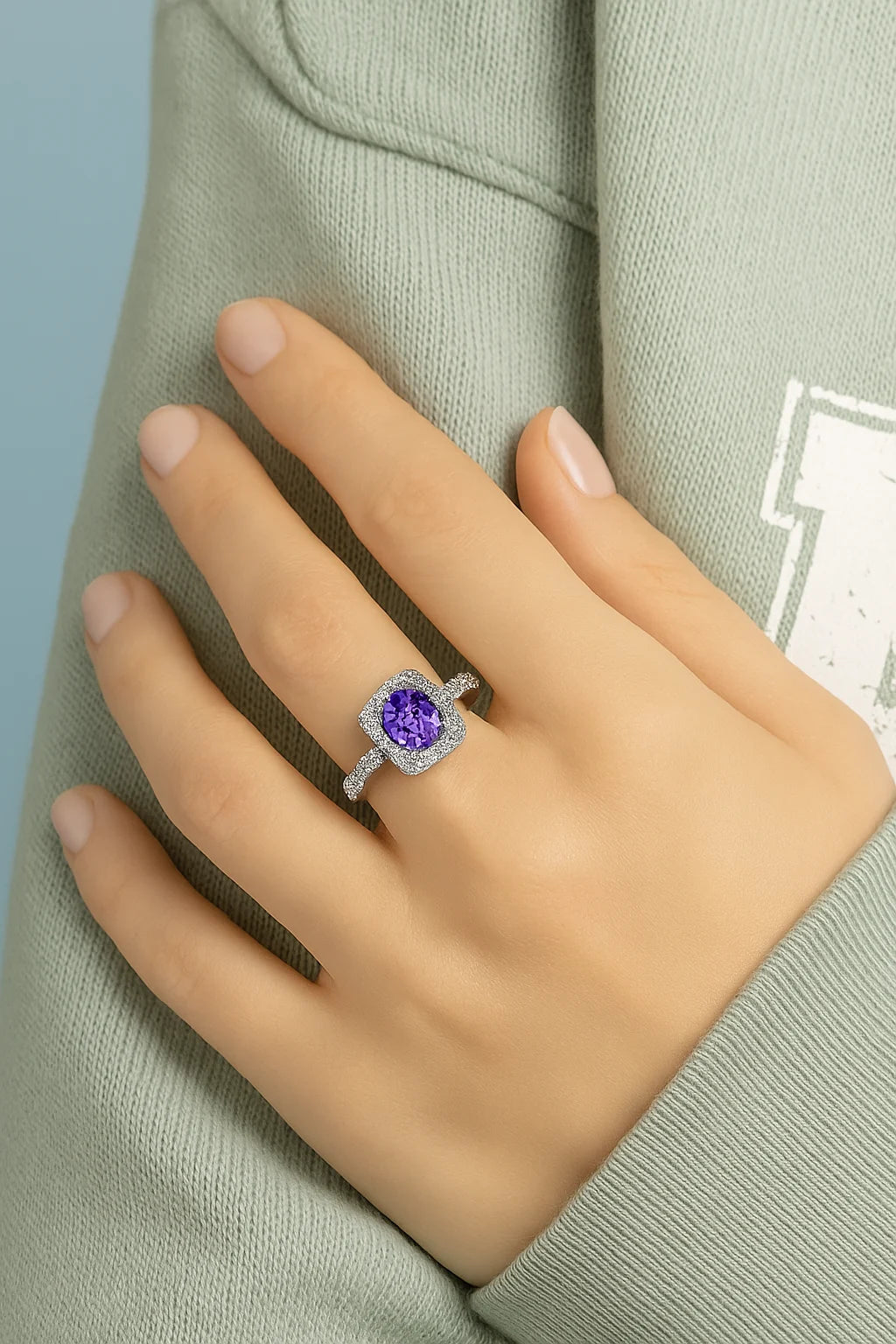 Model wearing Cavell Feel Timeless natural tanzanite ring in sterling silver surrounded by round-cut cubic zirconia accents