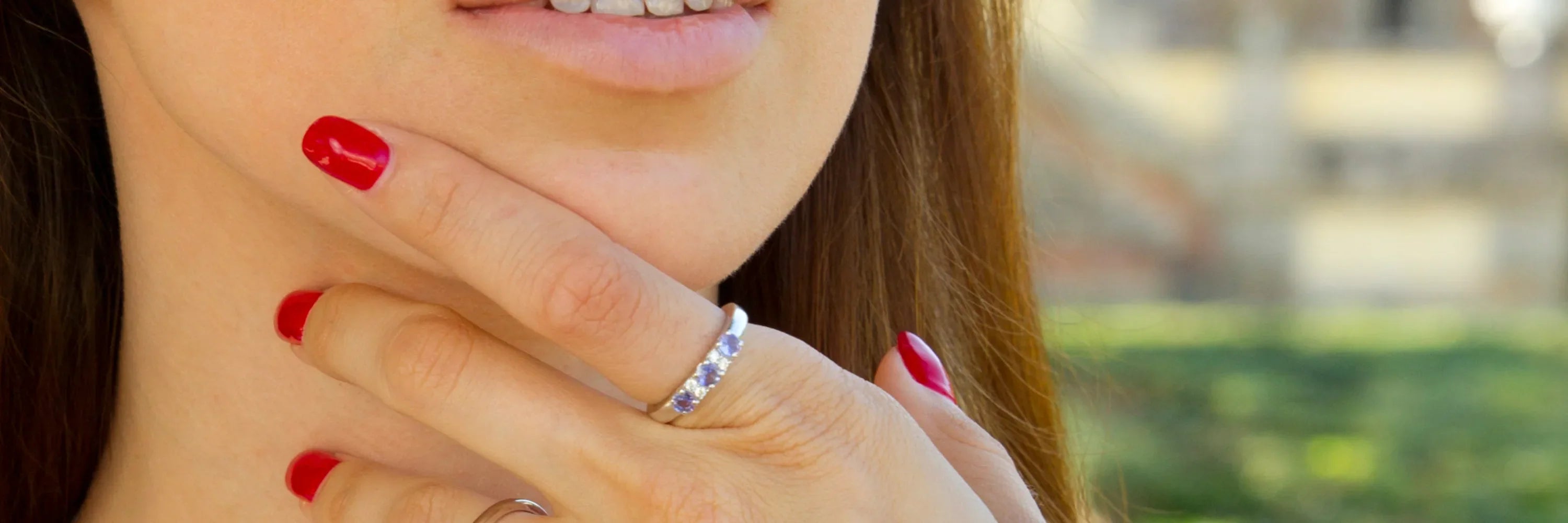 “Cavell Trilogy of Loyalty collection cover image showing a woman wearing a three-stone gemstone ring in sterling silver, symbolizing past, present, and future with hidden rose quartz for enduring connection