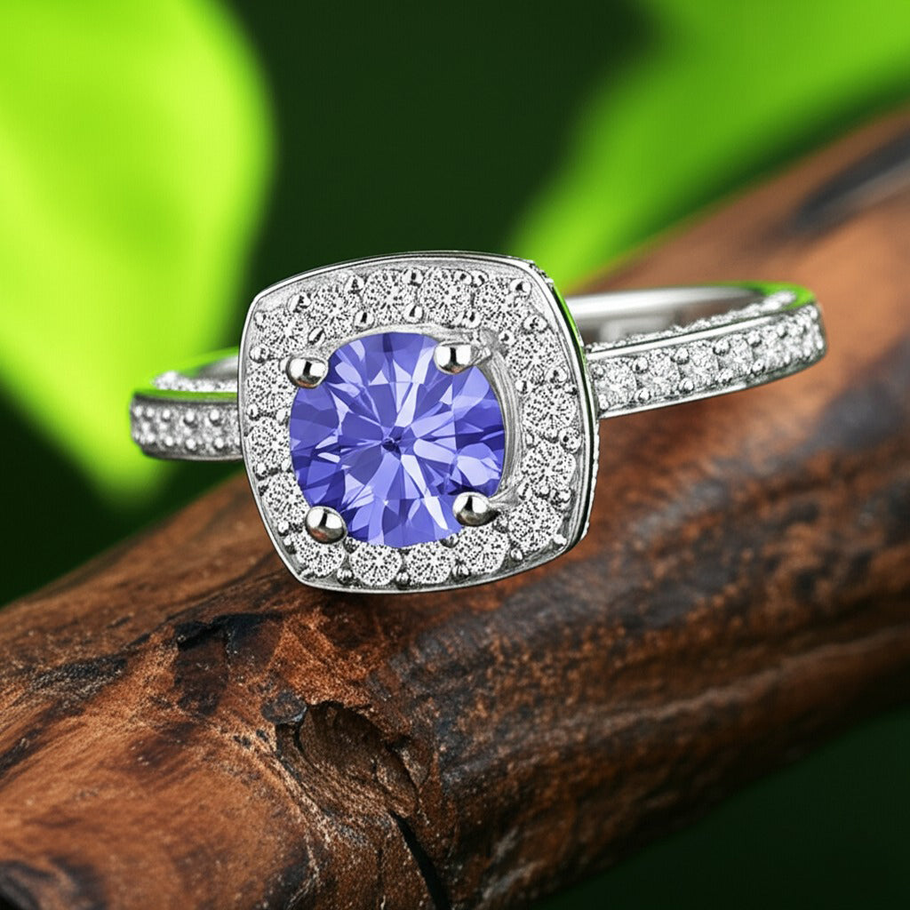 Cavell Everlasting Devotion natural tanzanite ring in sterling silver surrounded by round-cut cubic zirconia accents placed on a surface