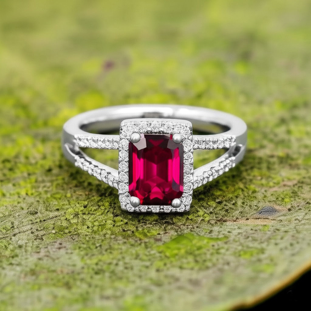 Cavell Classic Allure natural ruby ring in sterling silver surrounded by round-cut cubic zirconia accents placed on a surface