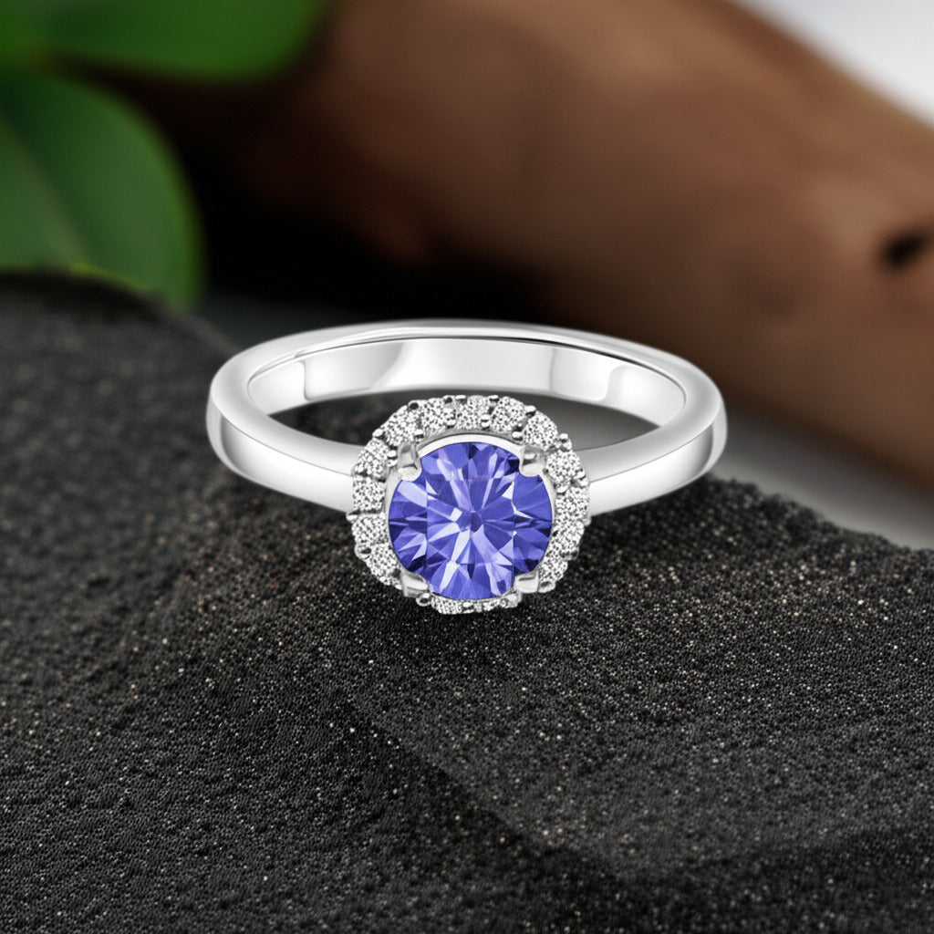Cavell Eternal Love natural tanzanite ring in sterling silver surrounded by round-cut cubic zirconia accents placed on a surface
