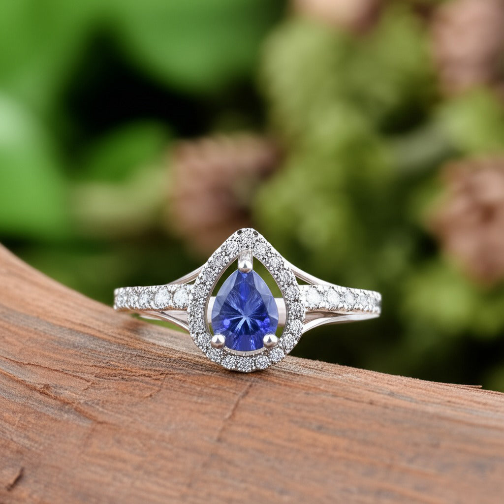 Cavell Tear Drop of Joy natural tanzanite ring in sterling silver surrounded by round-cut cubic zirconia accents placed on a surface