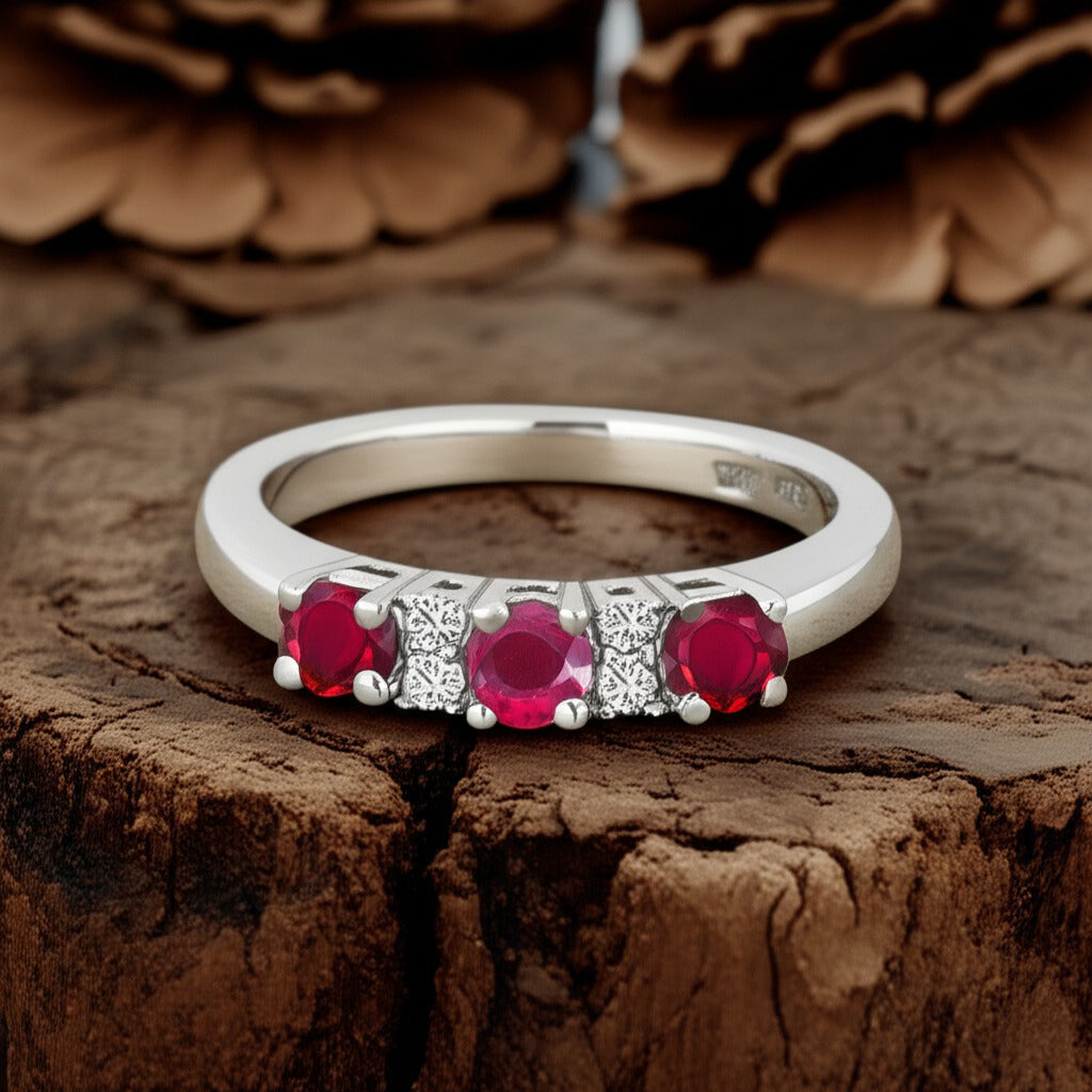 Cavell Trilogy of Loyalty natural ruby ring in sterling silver surrounded by round-cut cubic zirconia accents placed on a surface